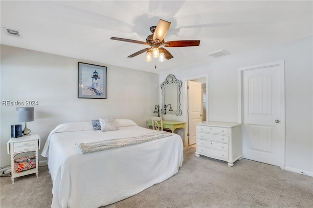 bedroom with ceiling fan and light carpet