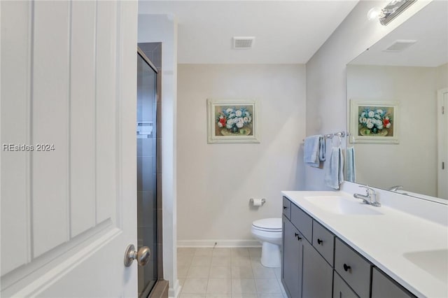 bathroom featuring vanity, a shower with shower door, and toilet