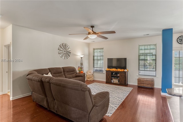 living room with ceiling fan and dark hardwood / wood-style flooring