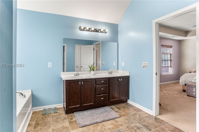 bathroom with vanity and a tub