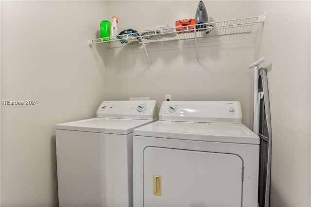 clothes washing area with washing machine and clothes dryer