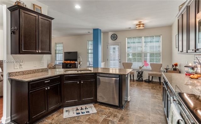 kitchen featuring sink, dark brown cabinets, stainless steel appliances, light stone counters, and kitchen peninsula