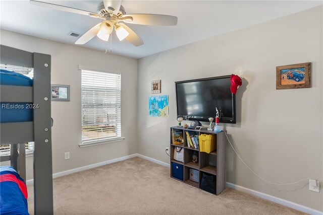 bedroom featuring light colored carpet and ceiling fan