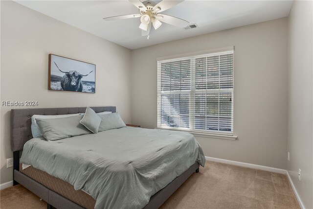 carpeted bedroom with ceiling fan