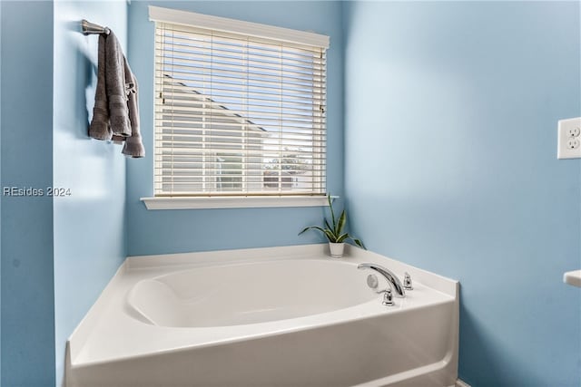 bathroom with a tub to relax in