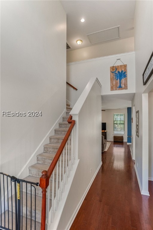 staircase with hardwood / wood-style floors