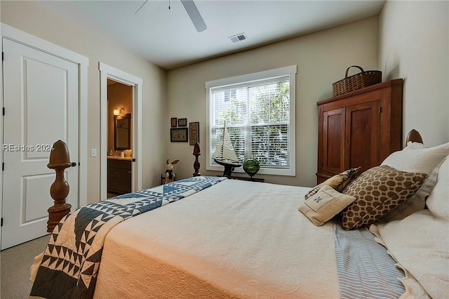 carpeted bedroom featuring ceiling fan and ensuite bath