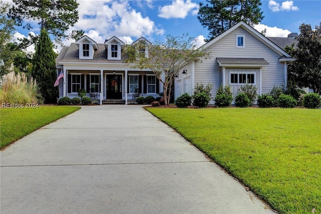 cape cod house with a porch, a garage, and a front yard