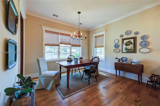 dining space with a notable chandelier, crown molding, and dark wood-type flooring