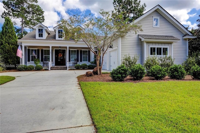 cape cod-style house with a garage, covered porch, and a front lawn