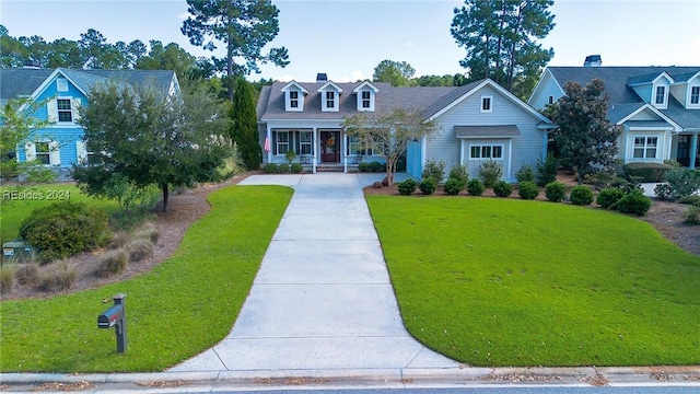 cape cod home featuring a porch and a front yard