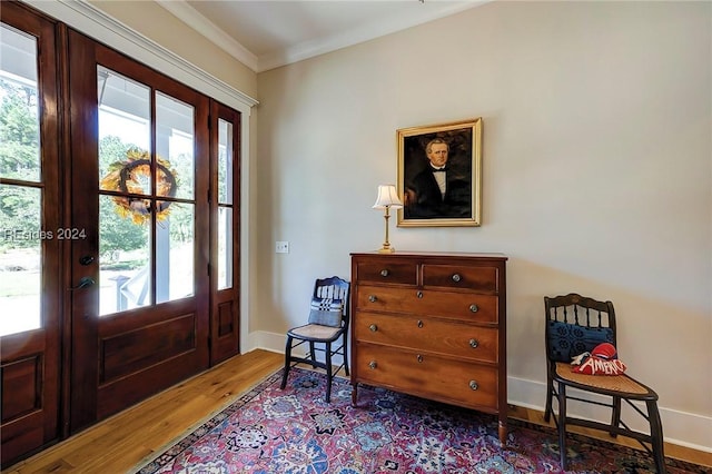 entrance foyer featuring crown molding and wood-type flooring