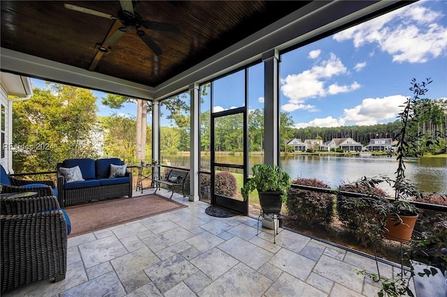 sunroom featuring a water view, ceiling fan, and wood ceiling