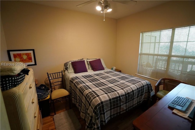 bedroom featuring ceiling fan and dark hardwood / wood-style floors