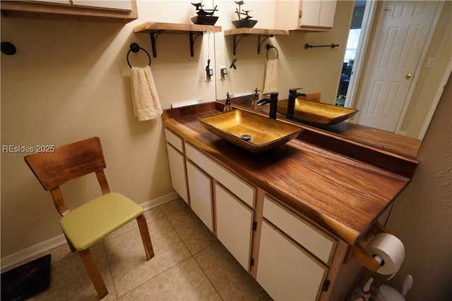 bathroom with tile patterned floors and vanity