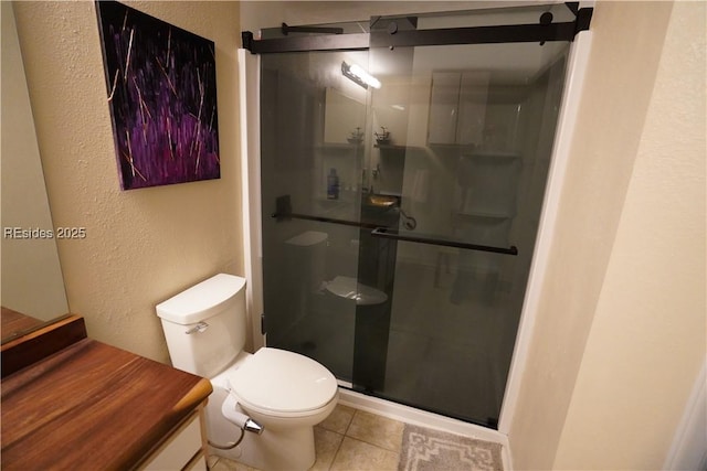 bathroom with an enclosed shower, tile patterned floors, and toilet