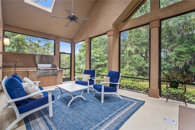 sunroom / solarium with ceiling fan and vaulted ceiling with skylight