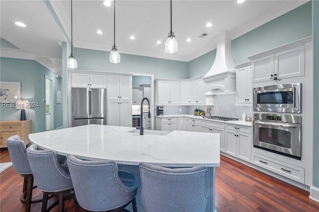 kitchen featuring tasteful backsplash, white cabinetry, sink, hanging light fixtures, and stainless steel appliances