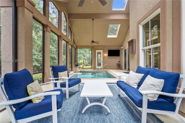 view of pool featuring a jacuzzi, ceiling fan, and a skylight