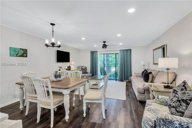 dining area featuring ceiling fan with notable chandelier and dark wood-type flooring