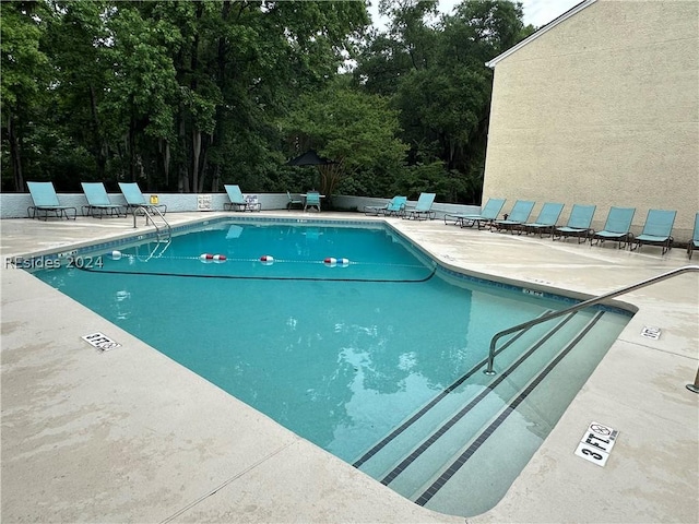 view of swimming pool featuring a patio area