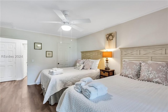 bedroom with ceiling fan, wood-type flooring, and ornamental molding