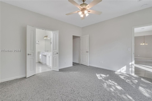 unfurnished bedroom featuring ensuite bath and ceiling fan