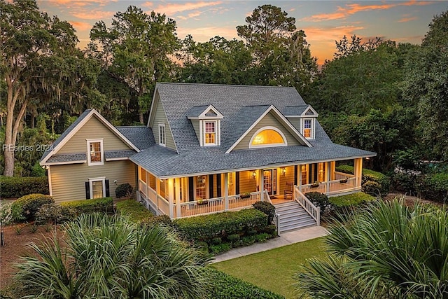 back house at dusk with covered porch