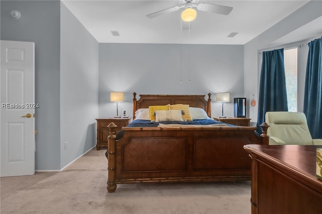 bedroom with ceiling fan and light colored carpet