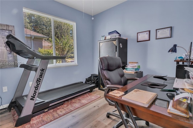 home office with light hardwood / wood-style floors