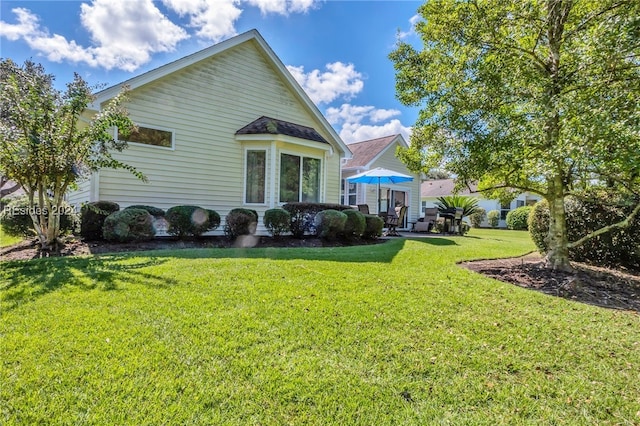 back of property featuring a lawn