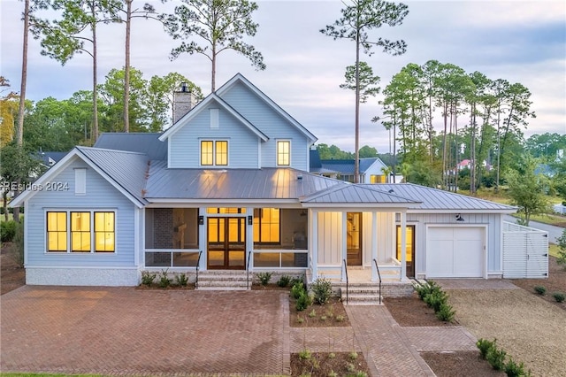 view of front of property featuring a garage and a porch