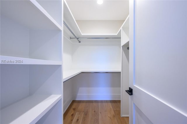 walk in closet featuring light hardwood / wood-style flooring