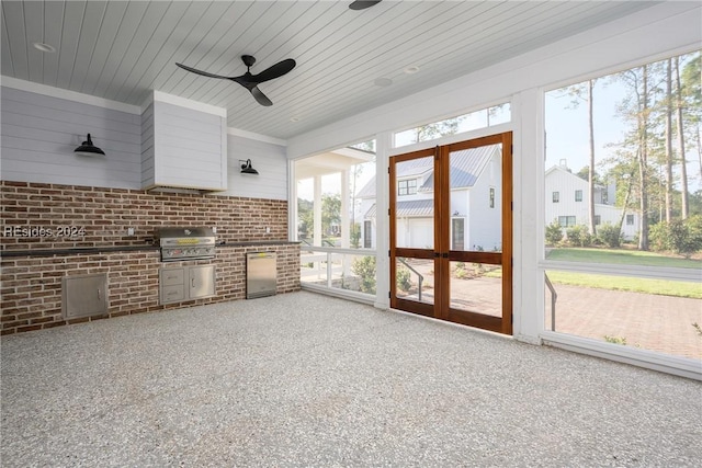 unfurnished sunroom featuring wood ceiling and ceiling fan