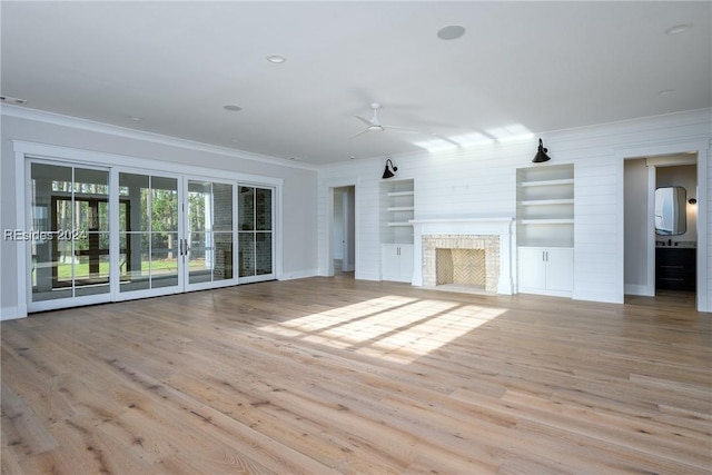 unfurnished living room featuring ceiling fan, ornamental molding, and light hardwood / wood-style flooring