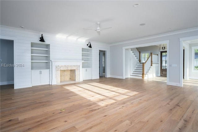 unfurnished living room featuring light hardwood / wood-style flooring, ornamental molding, and ceiling fan