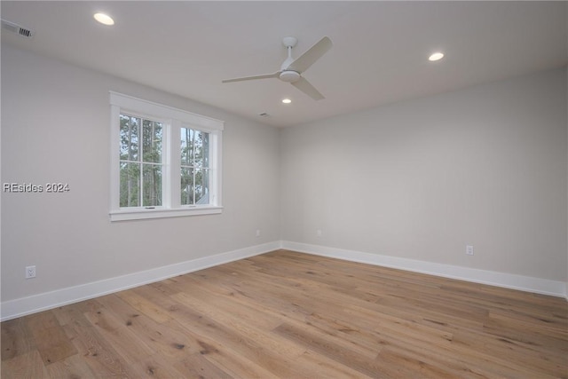 spare room with ceiling fan and light wood-type flooring