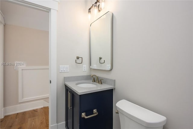 bathroom featuring vanity, toilet, and wood-type flooring