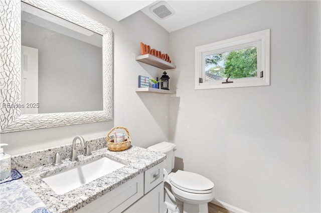 bathroom featuring vanity and toilet