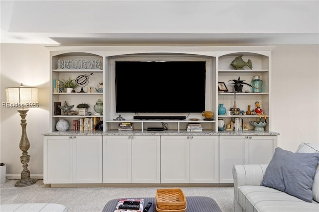 living room featuring light colored carpet and built in features