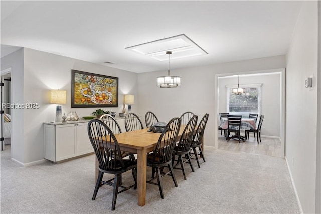 dining room featuring light colored carpet