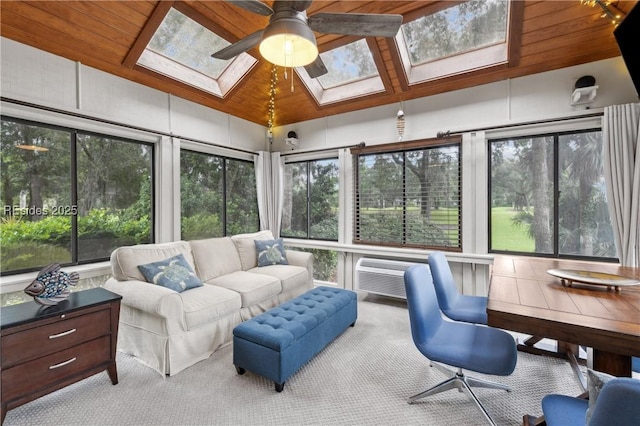 sunroom / solarium with ceiling fan, wooden ceiling, a wall mounted AC, and vaulted ceiling with skylight