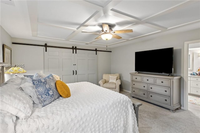 bedroom featuring a barn door, connected bathroom, light colored carpet, and ceiling fan