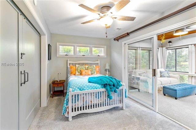 bedroom with light carpet, multiple windows, and ceiling fan