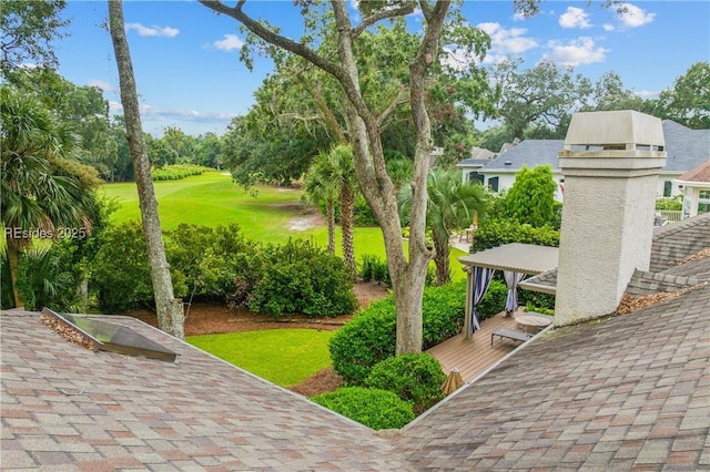 view of property's community with a yard