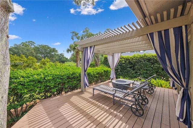 wooden deck featuring a pergola and an outdoor fire pit