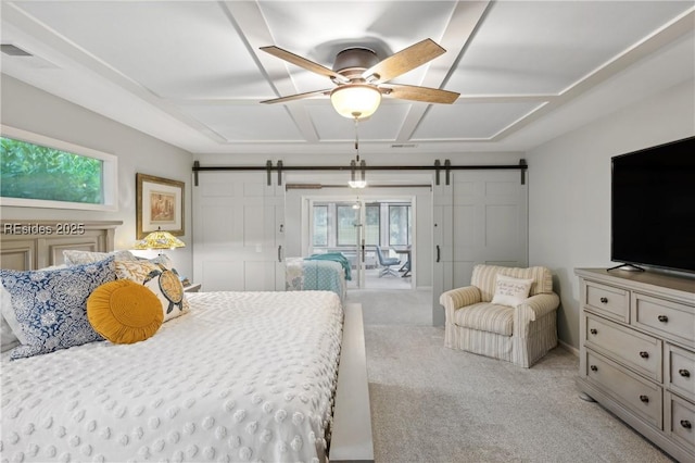 bedroom with a barn door, coffered ceiling, light colored carpet, and ceiling fan