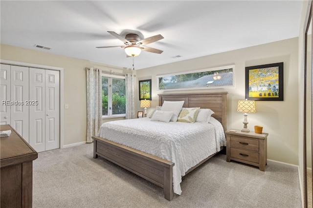 carpeted bedroom featuring ceiling fan and a closet