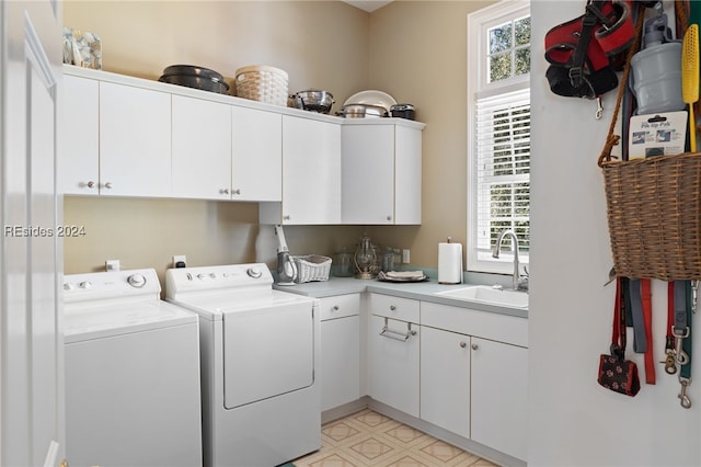 laundry room featuring cabinets, separate washer and dryer, and sink