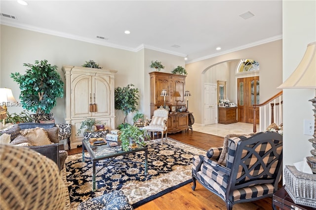 living room featuring crown molding and light wood-type flooring